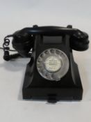 A 1960's G.P.O. bakelite telephone with pull out phone book section, rewired. H.15 W.24 D.18cm