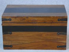 An Eastern teak and metal bound travelling casket with twin iron carrying handles. H.28xW.50xL.33cm