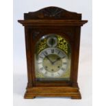 A late 19th century German carved oak cased chiming mantel clock, with movement stamped Gustav