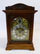 A late 19th century German carved oak cased chiming mantel clock, with movement stamped Gustav