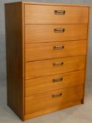 A mid century teak tallboy chest of six drawers with carved afromosia handles. H.107xW.75xL.40cm