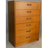 A mid century teak tallboy chest of six drawers with carved afromosia handles. H.107xW.75xL.40cm