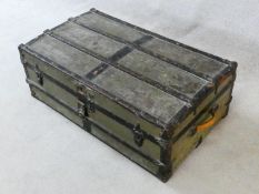 A vintage metal bound lidded travelling trunk with twin iron carrying handles. H.32xW.92xD.53cm