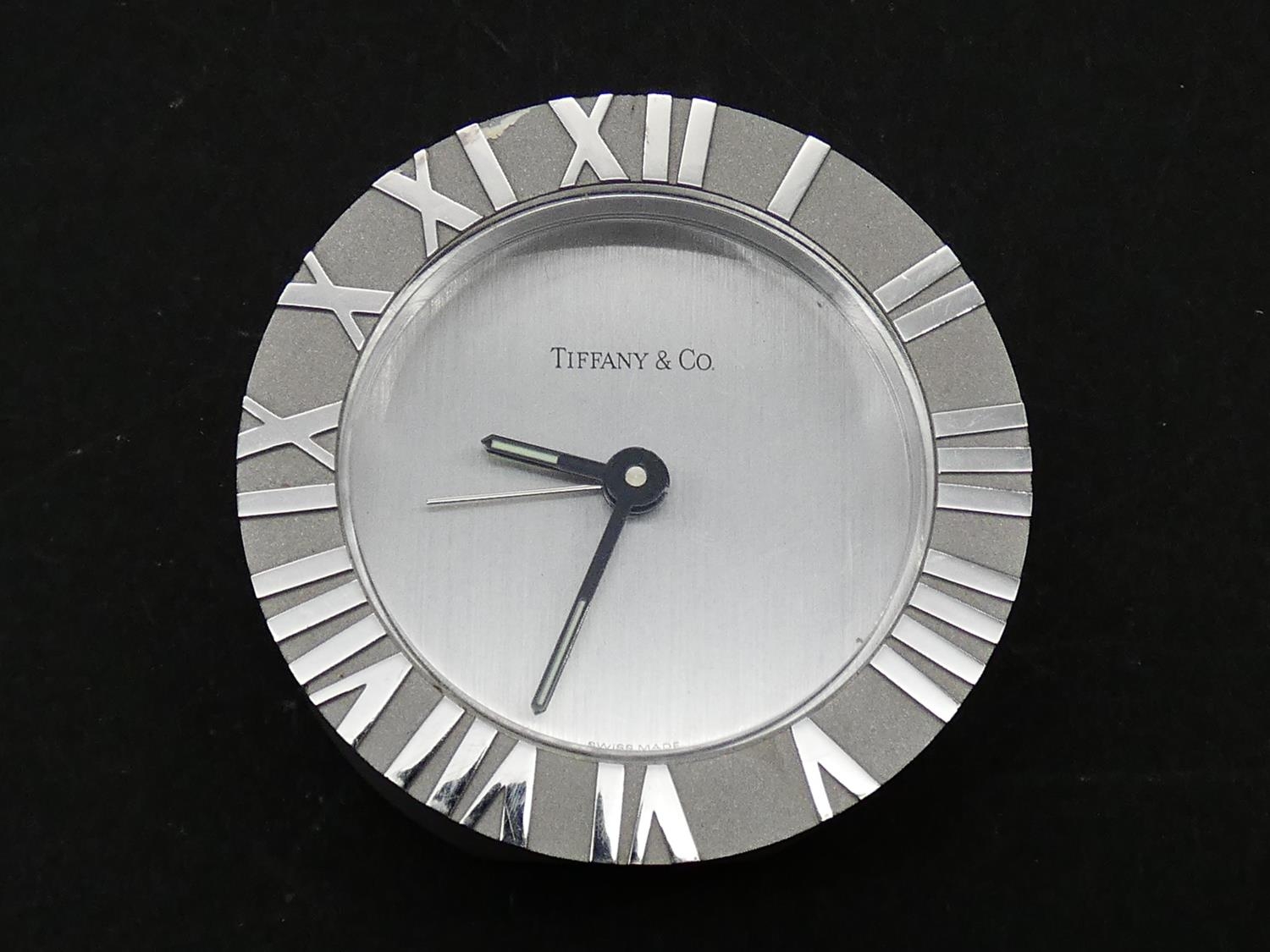 A Tiffany & Co Swiss made stainless steel Roman numeral quartz alarm clock with brushed chrome bezel