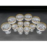 A set of six moulded glass and gilt rimmed champagne coupes and a similar smaller set. H.11 D.9cm (