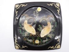 A Japanese lacquered wall hanging platter with painted and applied horn decoration depicting carp