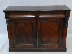 A Victorian mahogany chiffonier with frieze drawers above panel doors enclosing cellarette drawer on