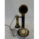 An early 20th century enamel on brass and bakelite candlestick telephone, rewired. Stamped W-30. H.