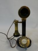 An early 20th century enamel on brass and bakelite candlestick telephone, rewired. Stamped W-30. H.