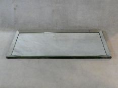 A contemporary wall mirror with bevelled glass plate and frame. H.177xW.76cm