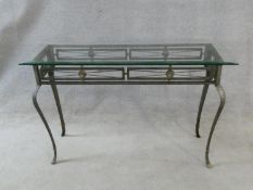 A metal framed Romanesque style console table with plate glass top on cabriole supports. H.77xW.