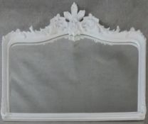 A white painted overmantel mirror with floral carved frame and cresting. H.99xW.126cm