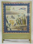 A vintage painted frame fire screen with glazed embroidered tapestry panel depicting the wildlife
