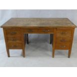 A mid century oak pedestal desk on square tapering supports. H.77 W.153 D.78cm