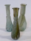 Three pale green and blue blown glass phials, possibly Roman. H.12cm