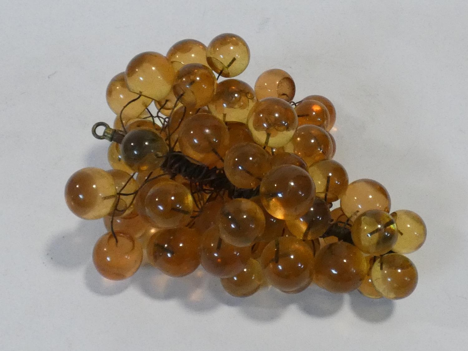 A vintage amber acrylic bunch of grapes mounted on wires. H.19xW.34xL.28cm