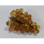 A vintage amber acrylic bunch of grapes mounted on wires. H.19xW.34xL.28cm