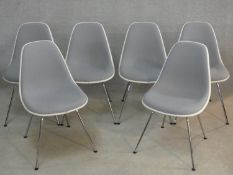 A set of six Eames style moulded and upholstered chairs for Vitra on chrome tubular supports. H.