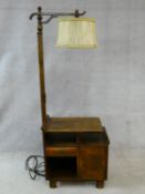 A mid century figured walnut Art Deco style standard lamp and integral side cabinet fitted with