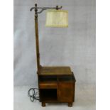 A mid century figured walnut Art Deco style standard lamp and integral side cabinet fitted with