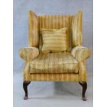 A Georgian style wing back armchair in ribbed velour upholstery on cabriole supports. H.110xW.85xD.