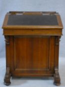 A 19th century oak Davenport, the leather inset lift up writing slope revealing fitted interior