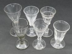 A collection of 19th century glasses. Including five petal cut conical gin glasses and a petal cut