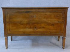 A 19th century provincial French chestnut two drawer commode with geometric lozenge inlay and