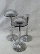 Three bar stools with moulded perspex seats and rise and fall action on chrome tulip bases. H.86cm