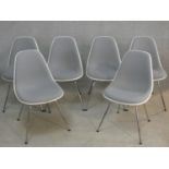 A set of six Eames style moulded and upholstered chairs for Vitra on chrome tubular supports. H.