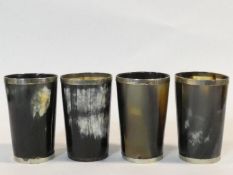A set of four antique horn cups with white metal collars to the rims. H.13cm