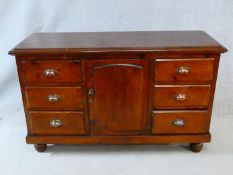 A late 19th century pine dresser with central panel door flanked by drawers on bun feet. H.84xW.