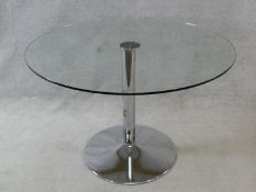 A plate glass topped dining table on chromium tulip base. H.74xD.110cm