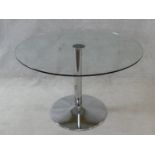 A plate glass topped dining table on chromium tulip base. H.74xD.110cm