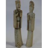 A pair of carved and stained Chinese bone figures of immortals. H.25cm