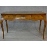 A Louis XV style walnut bureau plat with quarter veneered top and three frieze drawers raised on