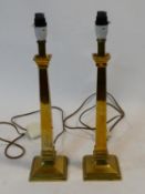 A pair of contemporary brass table lamps on stepped bases. H.46cm