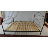 A wrought iron bedstead with support slats, to take a 5 ft mattress.