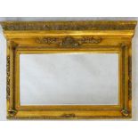 A Regency style gilt framed overmantel mirror with architectural pediment above bevelled plate