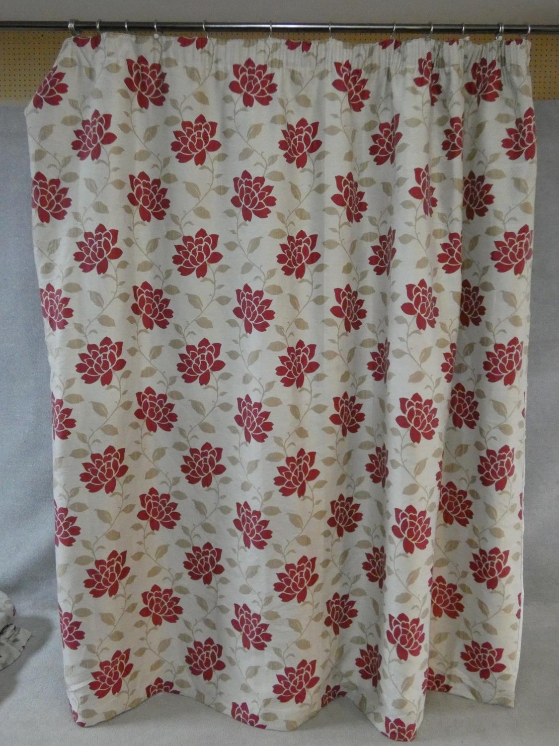 A pair of silk mixed lined curtains with stylised red floral design on a cream background. 223x175cm