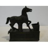 A vintage 'Trick Pony' cold painted cast iron novelty moving money box in the form of a horse
