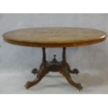 A Victorian burr walnut, satinwood and ebony inlaid tilt top dining table on quadruple turned