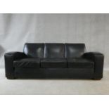 A contemporary three seater sofa in vintage style upholstered in midnight blue, from The Conran