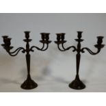 A pair of adjustable four sconce metal table candelabras in a bronzed finish. H.38cm