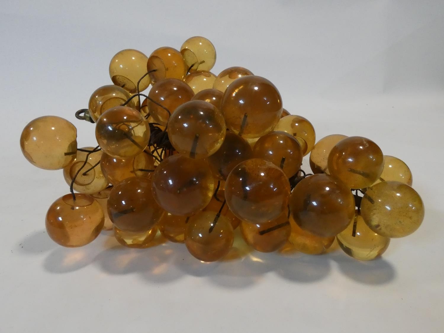 A vintage amber acrylic bunch of grapes mounted on wires. H.19xW.34xL.28cm - Image 2 of 4