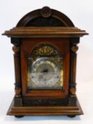 A late 19th century German mantel clock in architectural walnut case with bevelled glazed door and