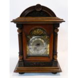 A late 19th century German mantel clock in architectural walnut case with bevelled glazed door and