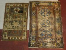 An Eastern rug with triple diamond medallions within multi borders and a similar rug with