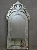 a Venetian style pier mirror with arched bevelled plate in foliate etched glass frame. H.142xW.72cm