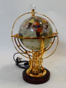 An electric marble chip inlaid acrylic globe on gilt metal stand with remote control for three